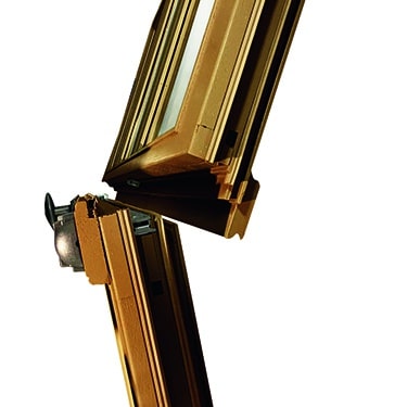 A close-up detail of a traditional wood French window opening to the inside.