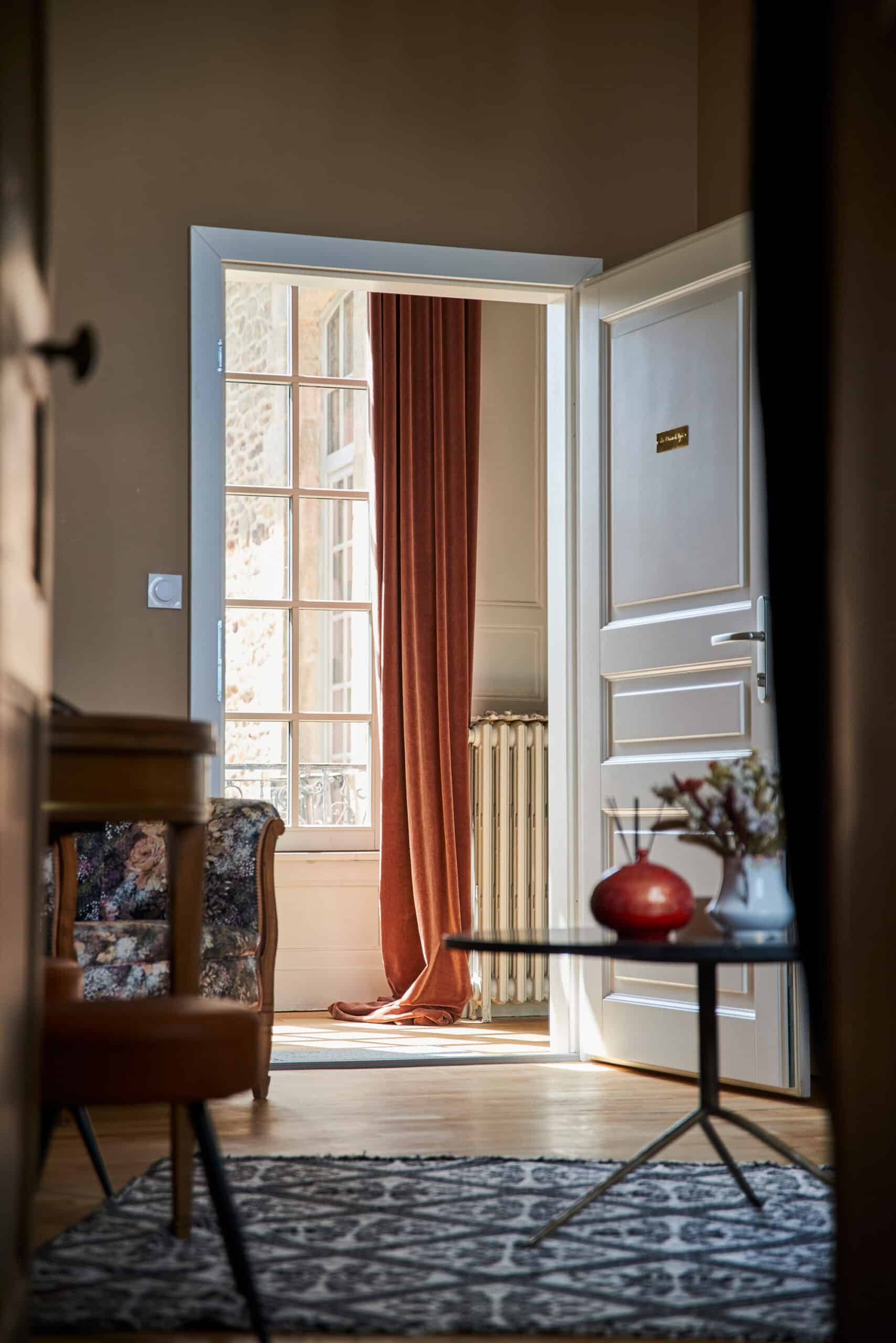 The interior view of a white custom wood door and window in a country house.