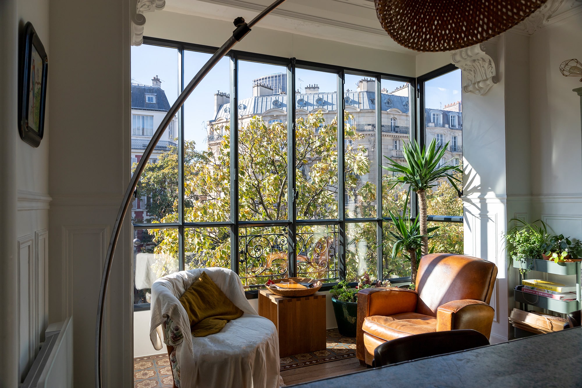 The interior of an apartment showcasing a wall of steel windows.