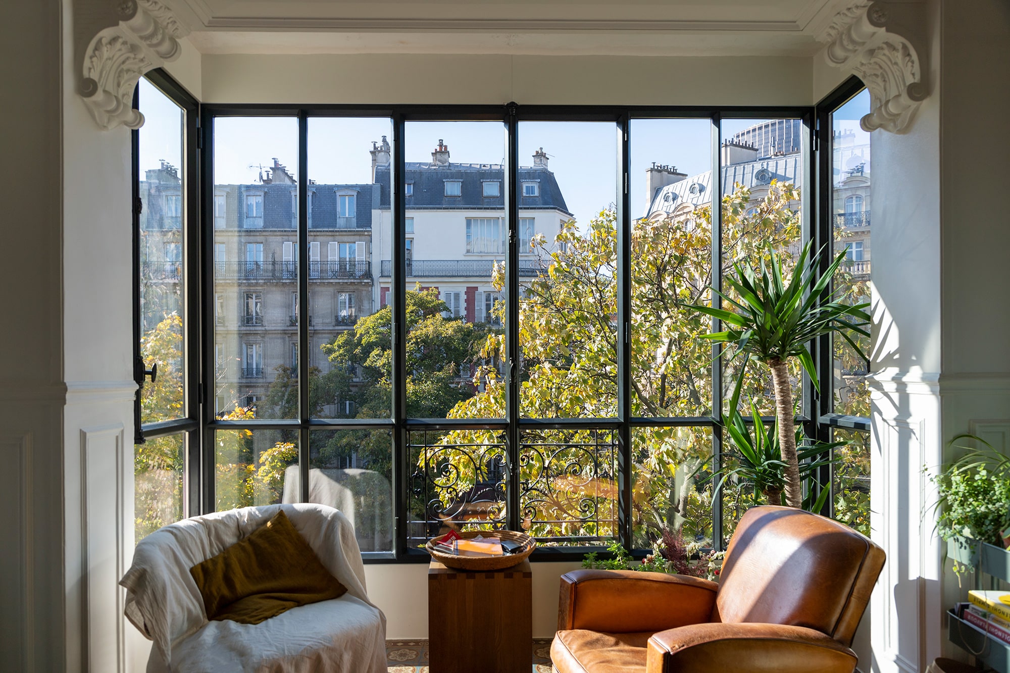 The interior of an apartment showcasing a wall of steel windows.