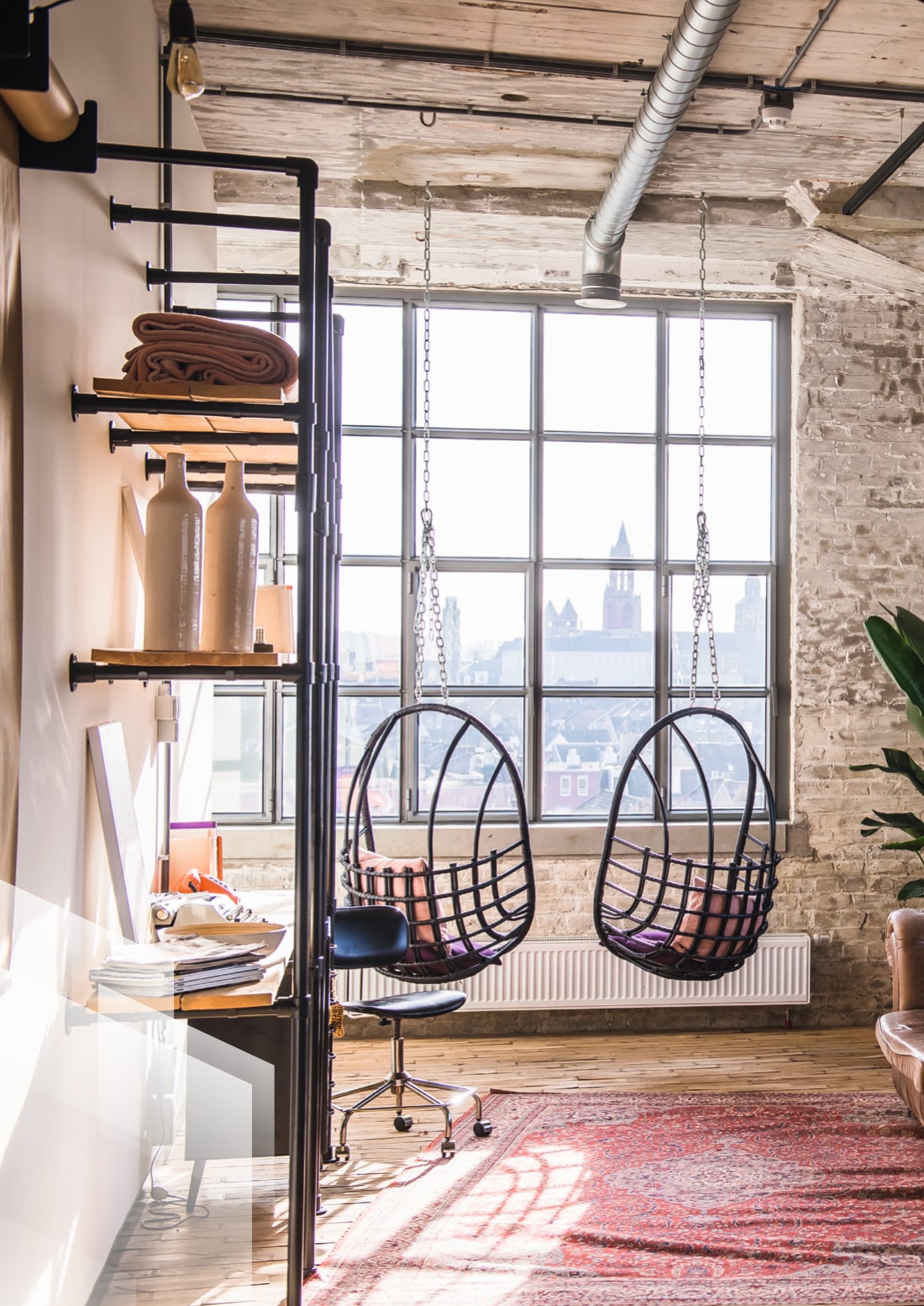 The interior of an apartment showcasing a wall of steel windows.