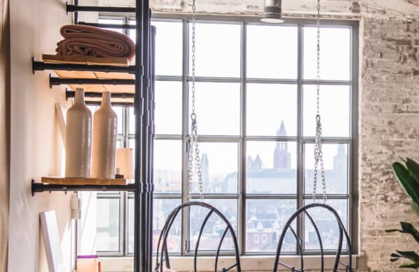The interior of an apartment showcasing a wall of steel windows.