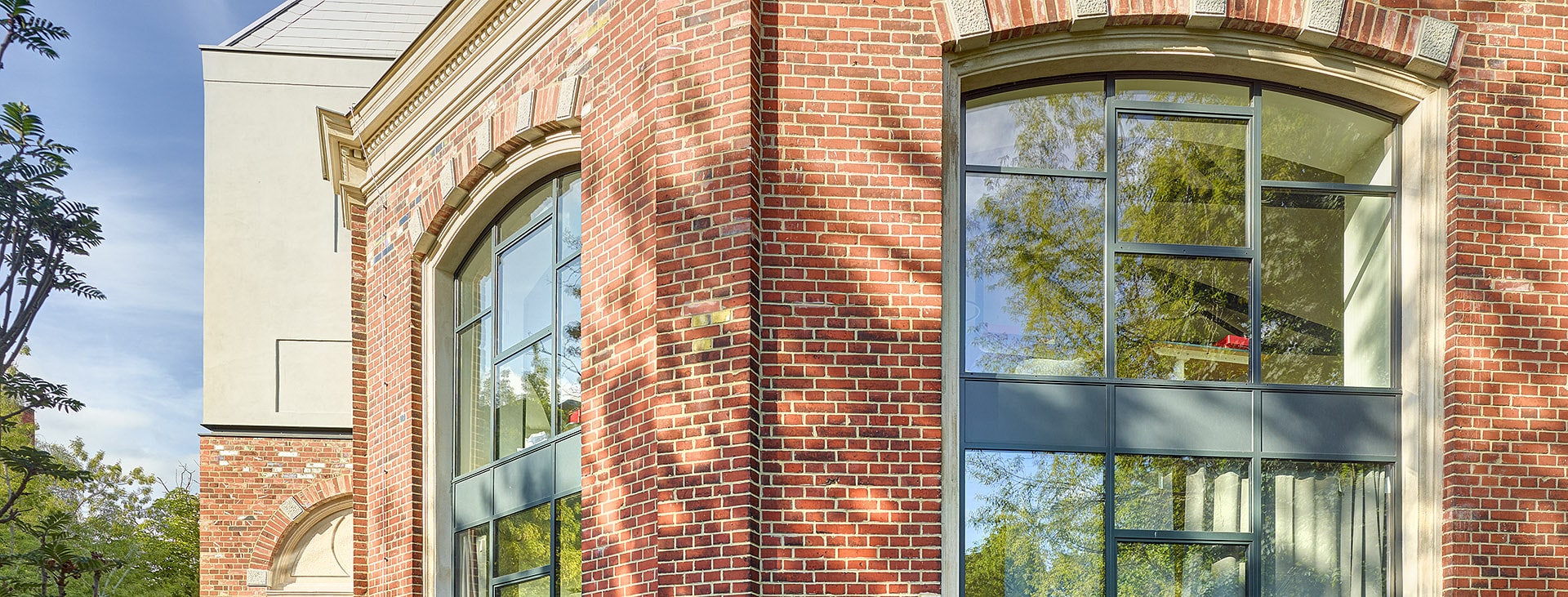 An exterior view of a brick building with banks of steel windows.